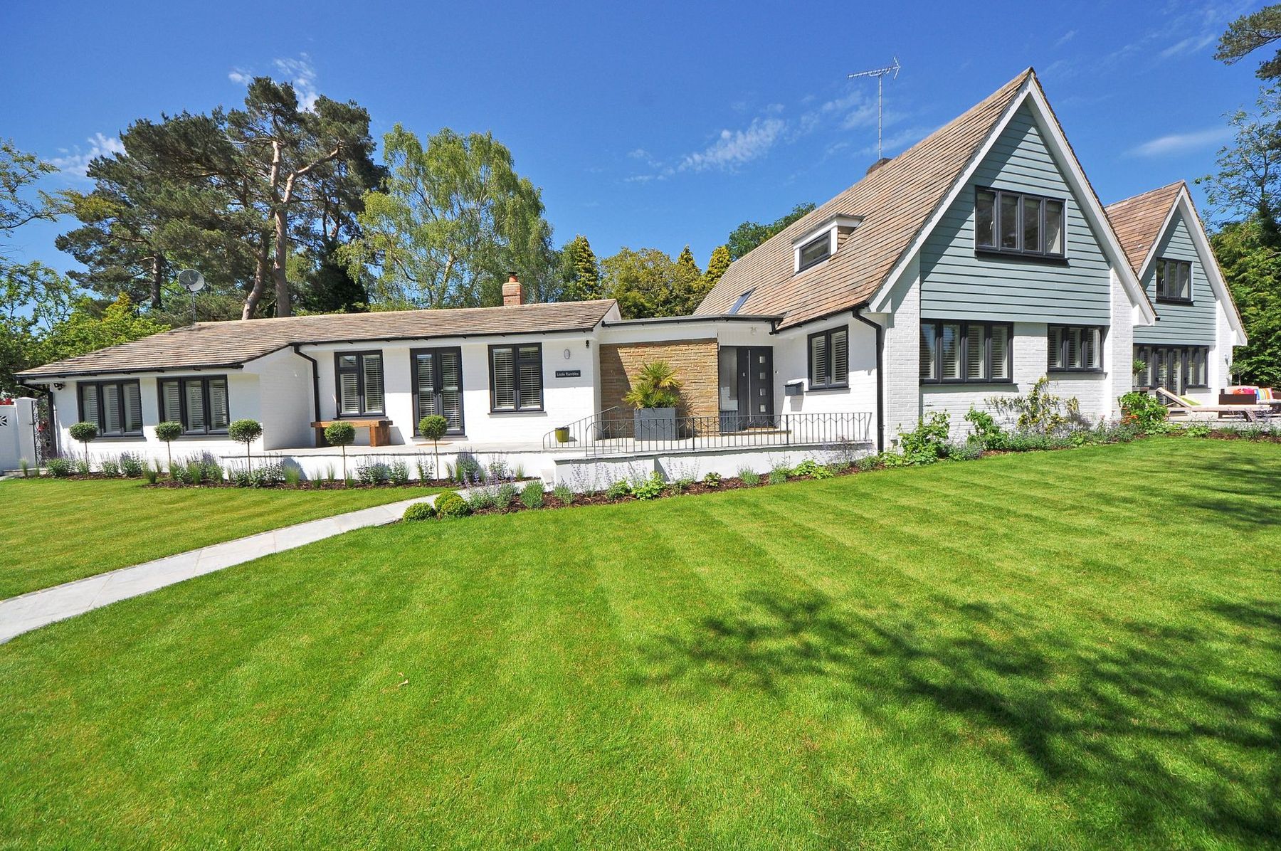 A house in Pittsburgh with a freshly mown, striped front lawn